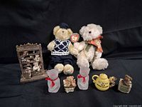 Group shot showing all eight items: two plush bears, resin bookshelf, ceramic teapot, two planter figurines, two frosted glass bears