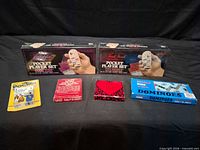 Front view of all six sealed game items laid out