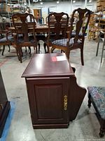 Cabinet closed front and side showing magazine rack and brass hardware