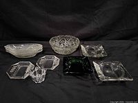 Overview of all 10 clear and black glass serveware and ashtray items