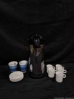 Group shot of airpot, mugs, bowls, saucers