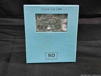 Front of boxed crystal cupcake showing product name and brand