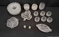 Full set laid out showing plates stacked, bowls stacked, leaf dish, tumblers, relish dish, round divided dish and shakers