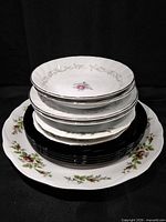 Stack of assorted bowls and plates showing quantity and patterns
