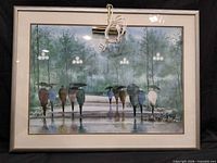 Front view of matted, glazed framed print with attached brass picture light