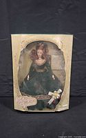 Front view of sealed Holiday Elegance doll box showing doll and accessories