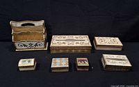 All eight Italian gilt wood items on black background