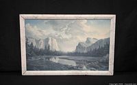 Front view of framed landscape painting