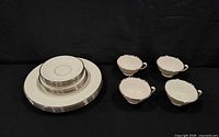 Full set showing stacked plates and four teacups