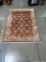 Full view of rug showing overall design, colors and size in relation to floor markings
