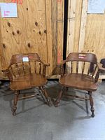 Pair of matching spindle-back armchairs front view