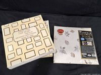 Two albums: beige slipcase and white memory book