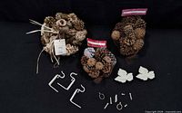 All items laid out: three pinecone bags, hooks, leaves, hardware
