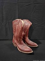 oblique view of both boots showing color, stitching, heel