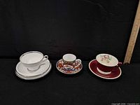 Three distinct teacup sets lined up