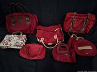 Group shot of all seven travel bags arranged on black background