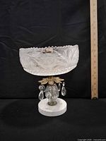 Front view of crystal compote on marble base with ruler for scale