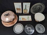 Group shot of entire lot showing cake carrier, plaques, platter, mixing bowl and glass plates
