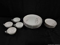 Group showing stacks of dinner plates, salad plates and five teacups