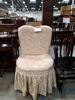 Front view of upholstered floral slipper chair