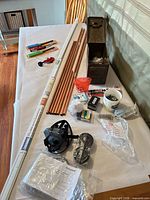 overview of all items on table including copper tubes, tools, fasteners, respirator, metal box