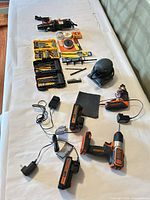 Overview of drill, heat tool, batteries, chargers, bit sets, solder supplies, palm sander and accessories