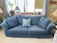 Front view of blue sofa with cushions