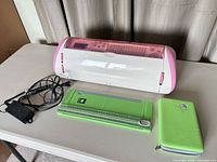 Cricut Expression machine, power adapter, green trimmer, green tool case