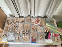 Full view of table showing grouped stamp sets, dies, rulers and tools