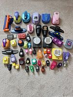 Full layout of all paper craft punches displayed on carpet
