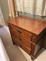 Front and side view of nightstand showing three drawers and overall condition