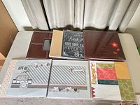 Group shot of four 12x12 albums and packaged scrapbook pages