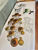 All items laid out: circular panel, bicycle, bird chime, hooks