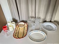 Group shot of all items including platters, plates, vases, candles, teapot