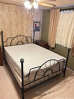Full view of queen metal bed with mattress and box spring