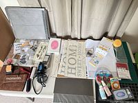 Overview of all scrapbooking tools, adhesives, paper and accessories laid on table