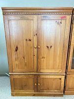 Front view closed doors of pine entertainment center