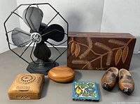 All lot items grouped: fan, three wood boxes, tile, clogs