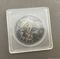 Obverse of 1908-S one peso coin in holder