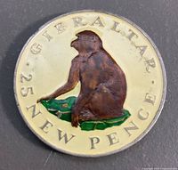Reverse of 1971 Gibraltar 25 new pence coin showing enamelled Barbary macaque design