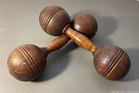 Pair of crossed wooden dumbbells overview