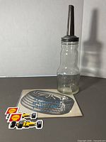 Full view of bottle, booklet and stickers