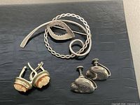 Brooch, cameo earrings pair, heart earrings pair displayed together