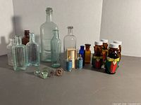 Front view showing entire assortment of bottles, vials, stoppers and prescription bottles