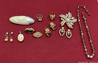 All eleven jewelry items displayed on red background