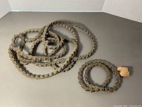 Entire coiled leather link belt displayed on table