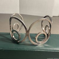 Front view of sterling silver openwork swirl cuff bracelet