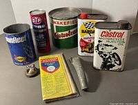 Group view of booklet, six tins, metal fitting and tube