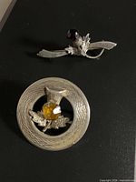 Both brooches together for size comparison