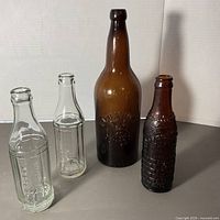 Group shot of four bottles showing relative sizes and colors
